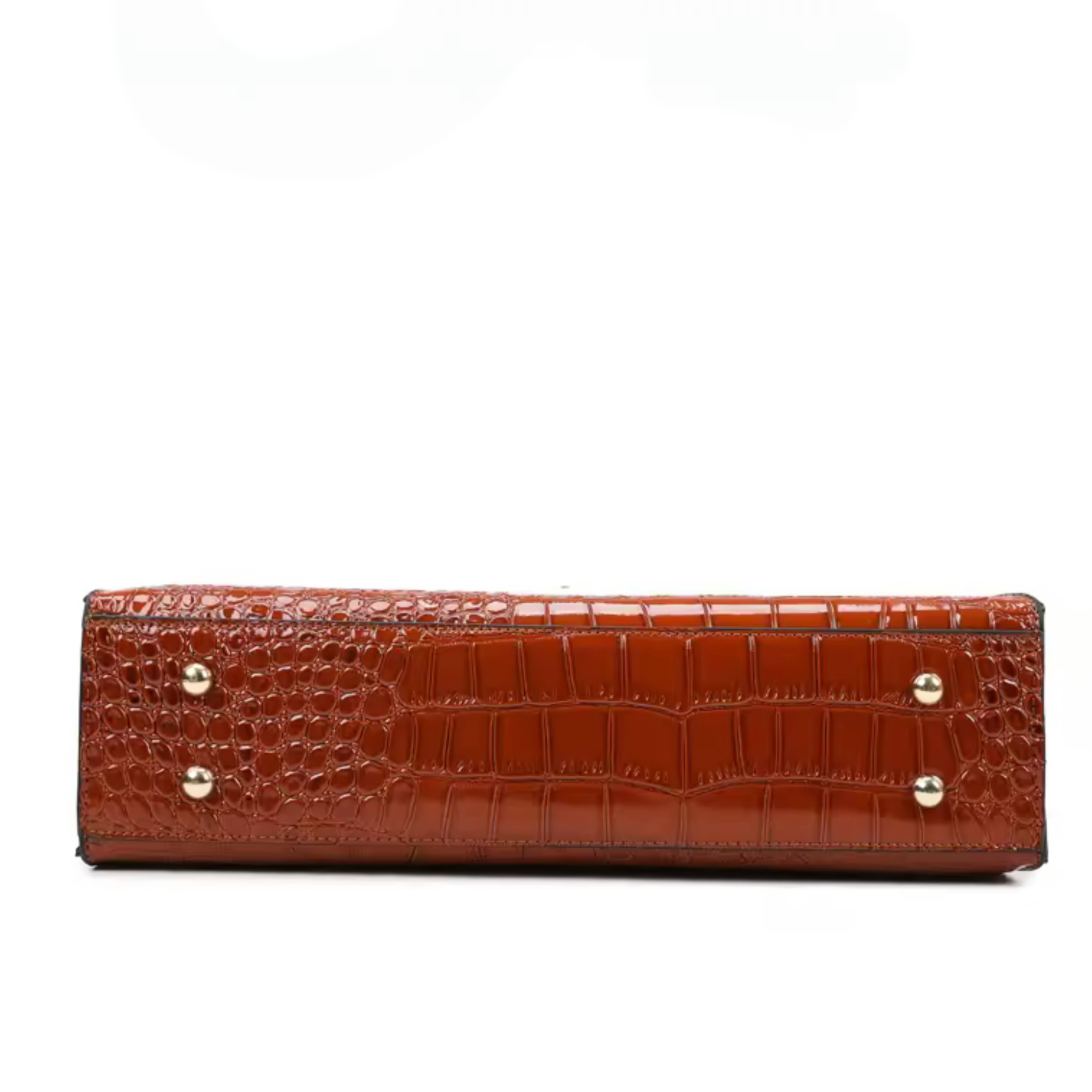 Gilded Croc Baguette Shoulder Bag cognac by TIKORI LONDON. Designed with a structured architectural frame and a glossy crocodile-embossed finish, it brings a "quiet luxury" aesthetic to your wardrobe at a fraction of the cost. Bottom part of the bag showing the golden hardware leg in a fully white background. 