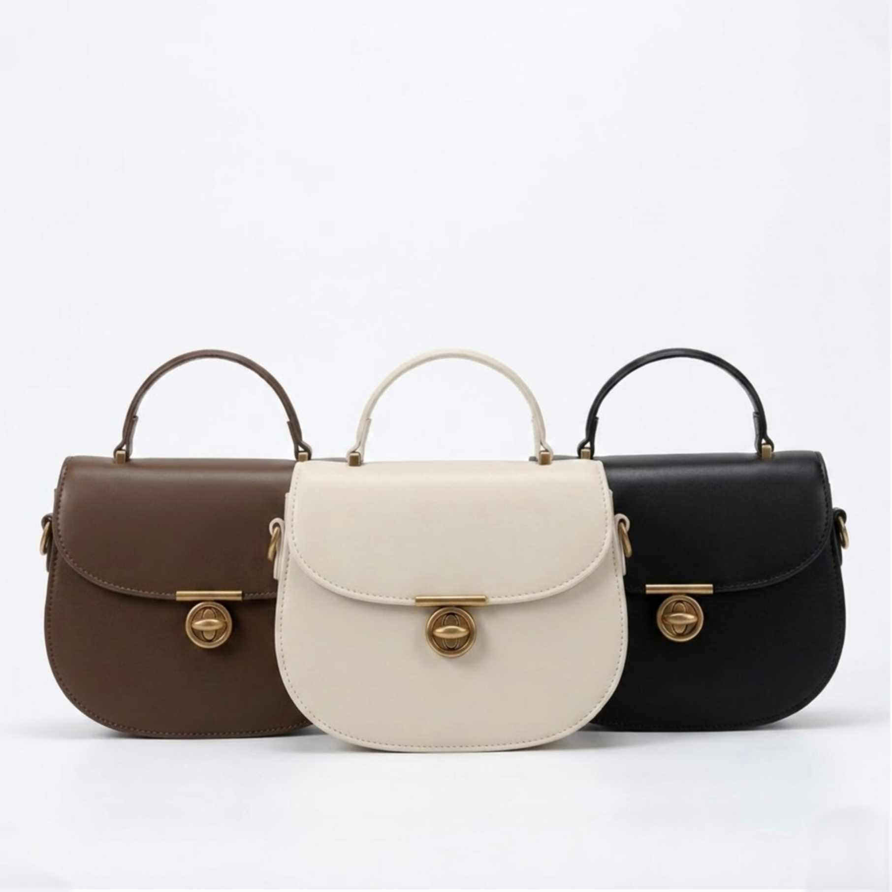Luna saddle bag - Black - TIKORI LONDON. Black, Brown , and Ivory all 3 bags are on the display showing front profile of the bag in a fully white background 