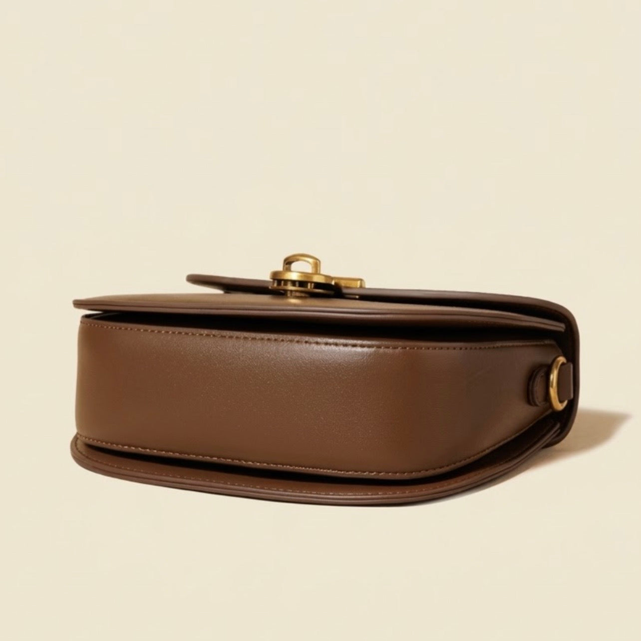 Luna Saddle Bag - Brown by TIKORI LONDON. Bottom of the bag showing on the picture. 