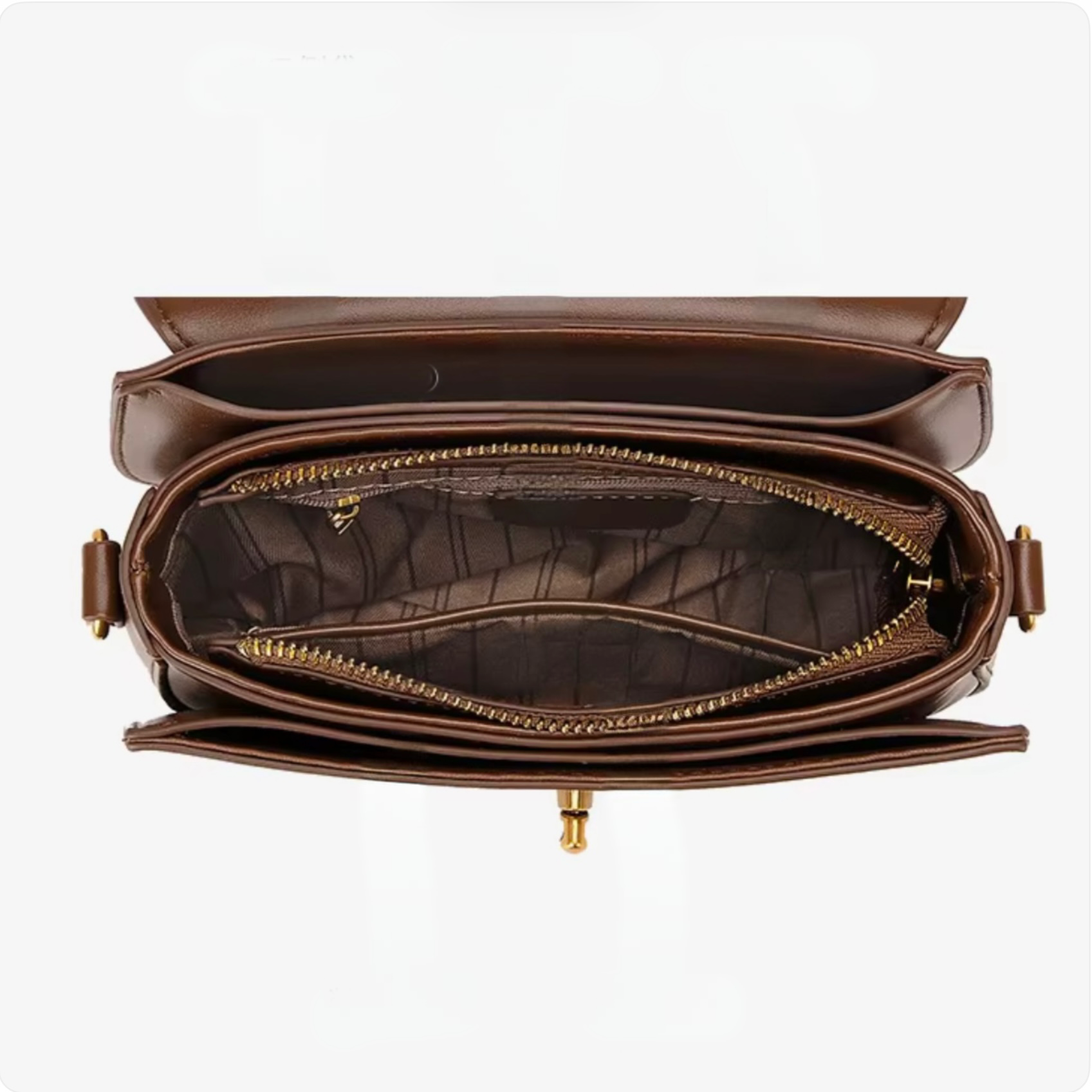 Luna Saddle Bag - Brown by TIKORI LONDON. Inside of the bag showing in the picture. Inside material and golden zipper detail can be seen. 
