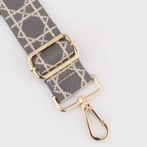 Grey  Tikori London Checkered Lines Crossbody Strap with adjustable length laid and small part of the stylish pattern displayed. Golden hardware also showing in the picture in a white background.