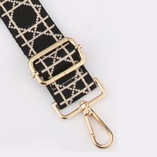 Black Tikori London Checkered Lines Crossbody Strap with adjustable length laid and small part of the stylish pattern displayed. Golden hardware also showing in the picture in a white background.