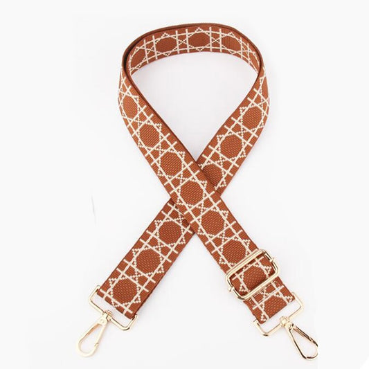 TIKORI LONDON checkered lines tan crossbody strap laid flat showing pattern and adjustable length. Golden hardware showing in a white background.
