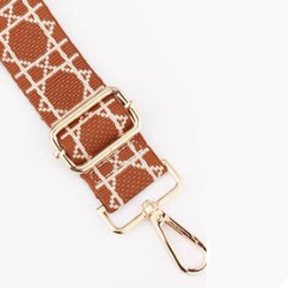 TIKORI LONDON checkered lines tan crossbody strap laid flat, small part of the golden hardware showing in a white background.