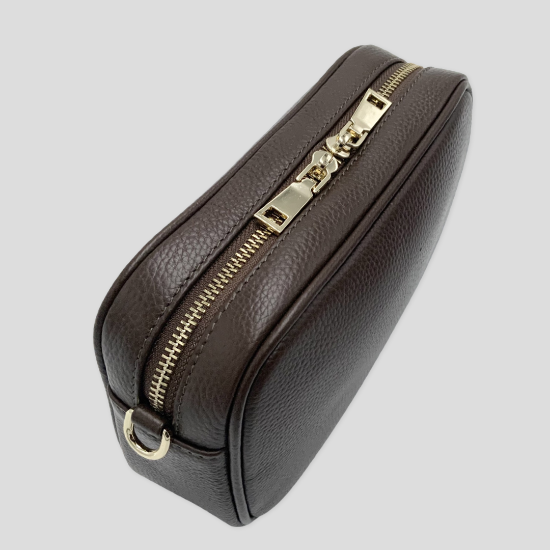Classic elegance with practicality and versatility in mind. TIKORI classic dark brown by TIKORI london. Genuine leather crossbody bag. Side and back profile of the bag showing in the picture. Golden tone hardware shows in white background. 