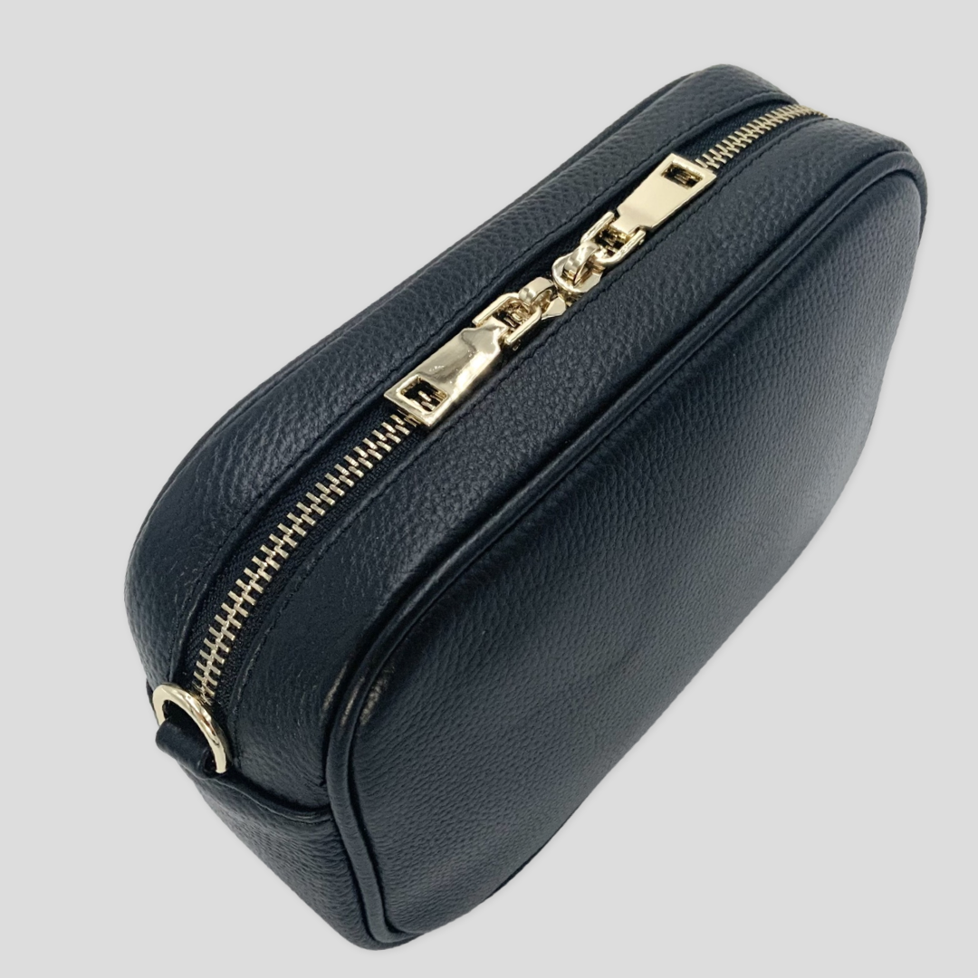 Classic elegance with practicality and versatility in mind. TIKORI classic Black by TIKORI london. Back profile of the bag shows with golden tone hardware in the white background