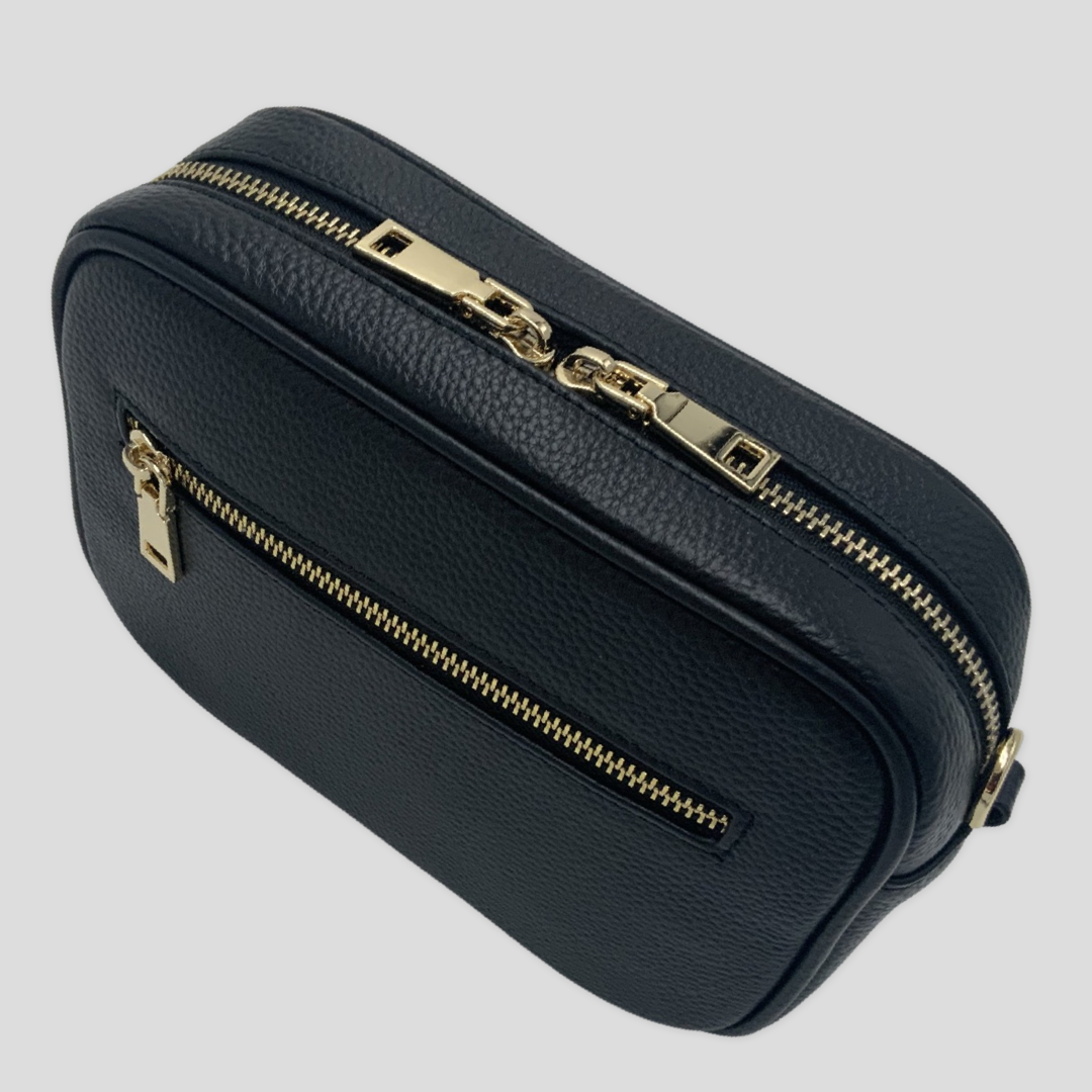Classic elegance with practicality and versatility in mind. TIKORI classic Black by TIKORI london. Front profile of the bag showing with golden tone hardware. Front pocket and close up detail of the pocket shows in fully white background.