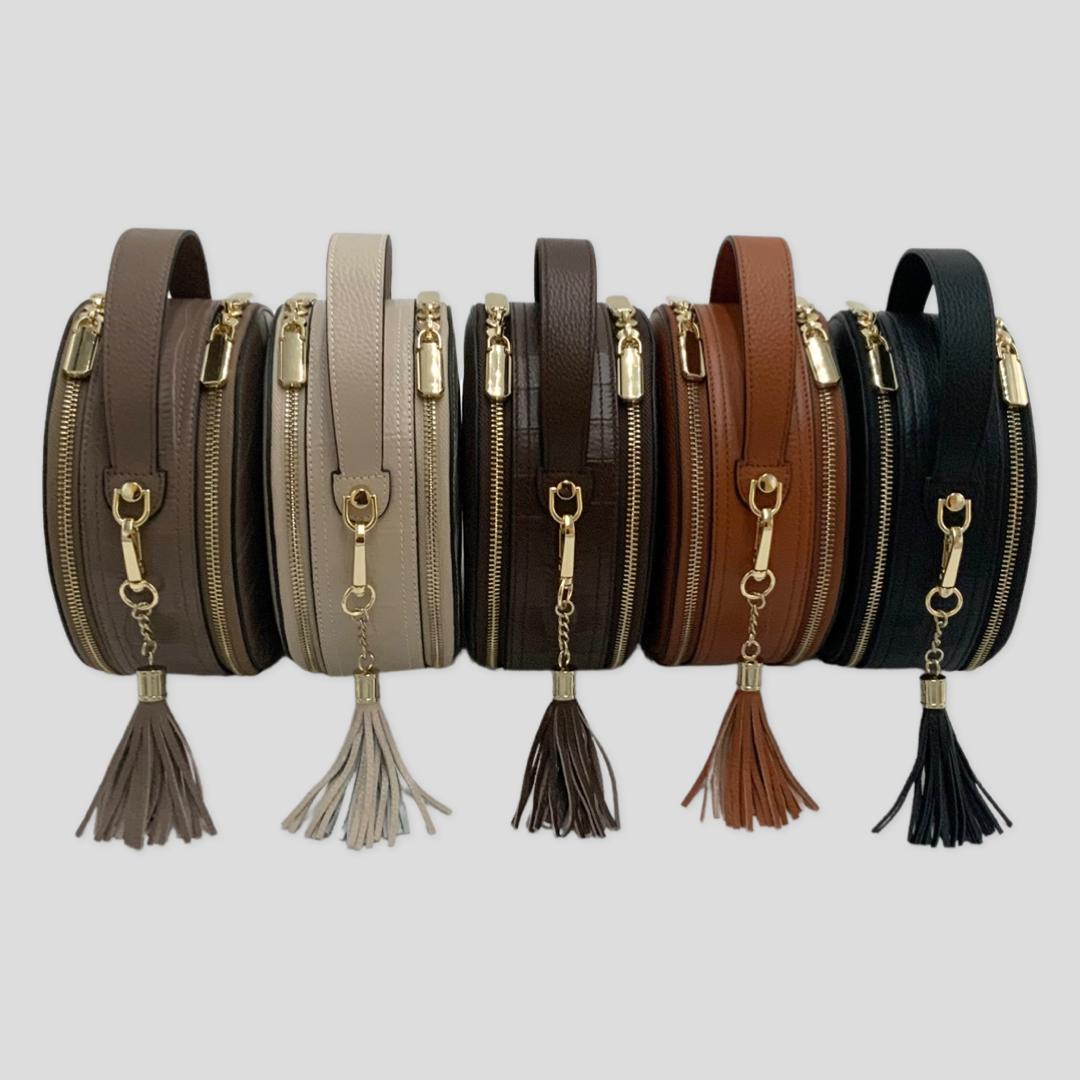 Cleopatra by Tikori London. leather circle crossbody bag collection with dual zippers, crafted in leather with sleek, modern design. All 5 colours bag showing in the picture. 