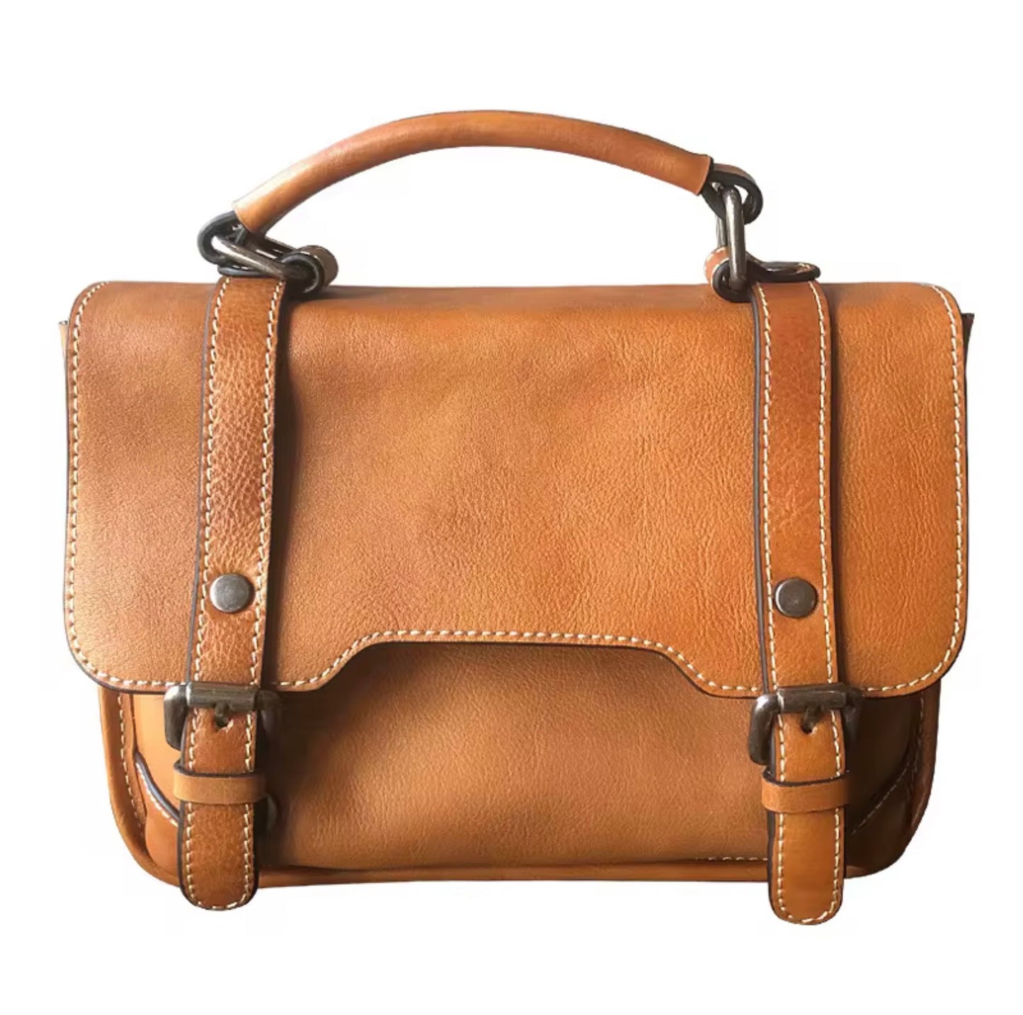 Heritage leather satchel messenger bag with top handle - Warm honey by TIKORI London. Crafted from premium genuine leather, this bag features a structured silhouette that maintains its sophisticated shape whether you’re heading to a boardroom meeting or a weekend brunch.
Front profile of the bag in a white background can be seen in the picture, 