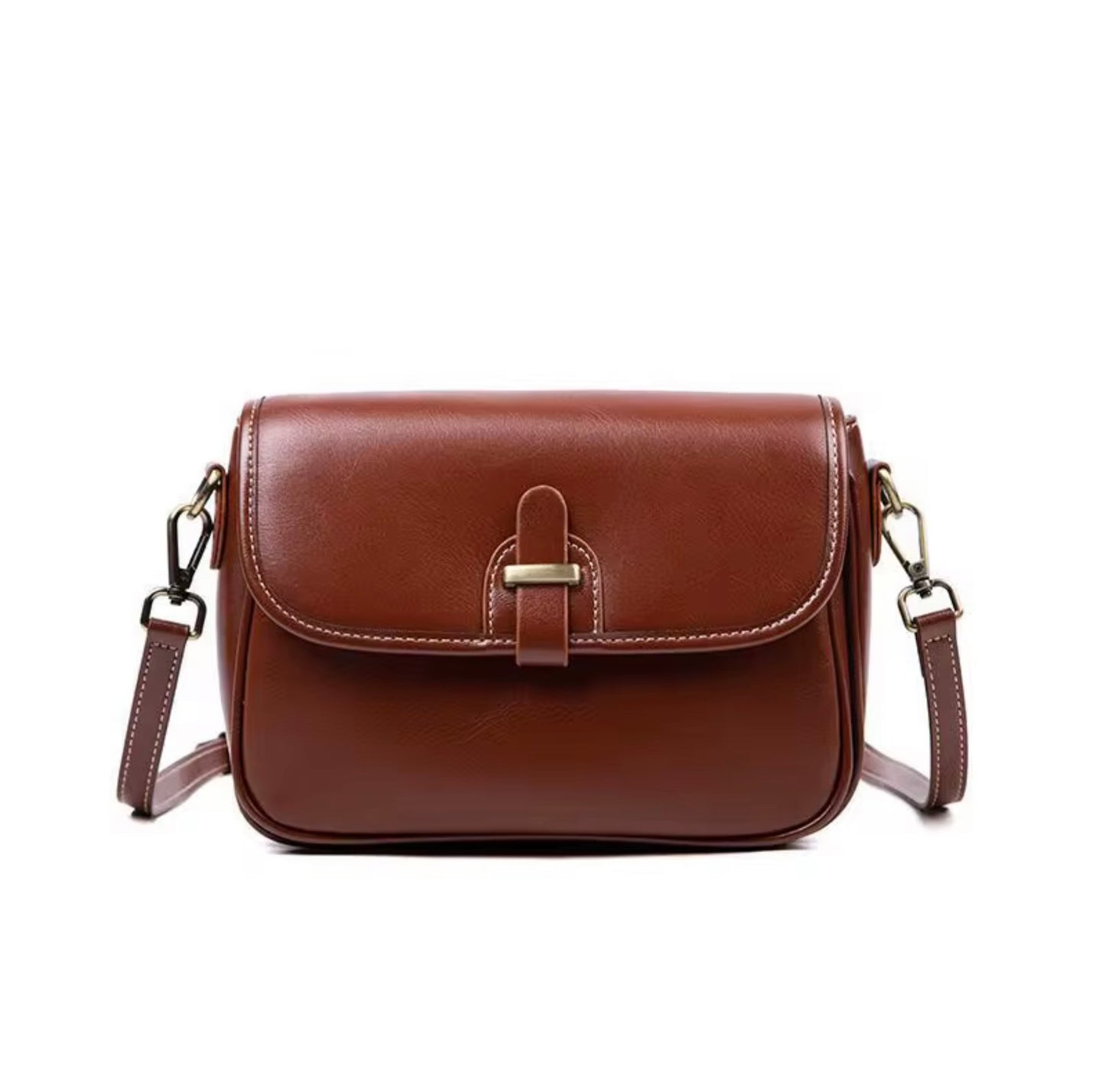 Heritage Cross Body Bag - Mahogany by Tikori London. Bag features a rich, mahogany toned finish that develops a unique patina over time, making it truly yours. Picture shows the front details of the bag  in a white background. 