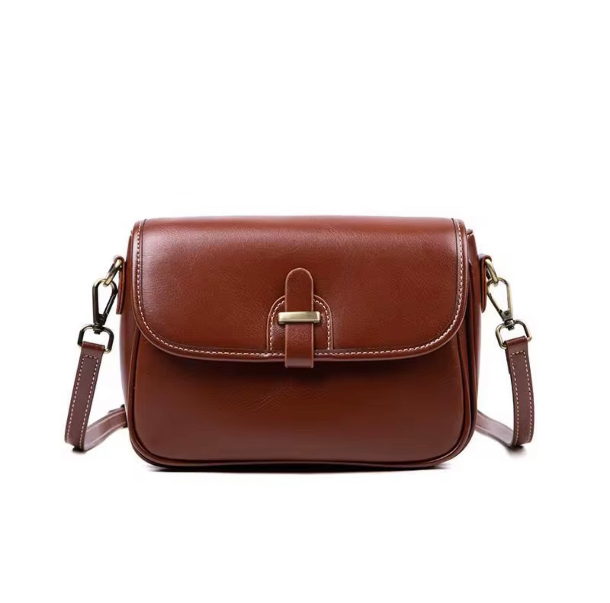 Heritage Cross Body Bag - Mahogany by Tikori London. Bag features a rich, mahogany toned finish that develops a unique patina over time, making it truly yours. Picture shows the front details of the bag  in a white background. 