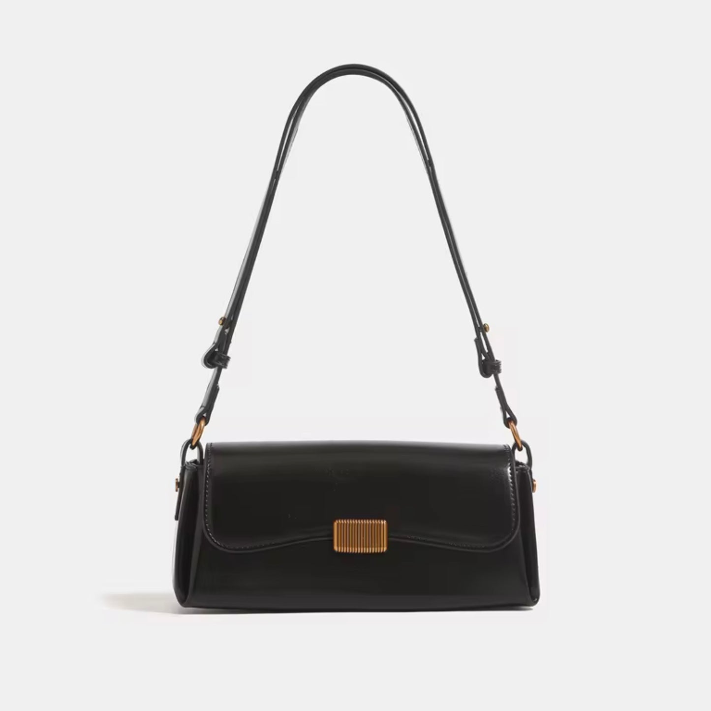 Crimson Muse Shoulder Bag - Black by TIKORI LONDON. Features a structured, elongated "baguette" body with clean, sharp lines and a narrow profile designed to sit snugly under the arm. Picture shows the front profile of the bag with top handle.