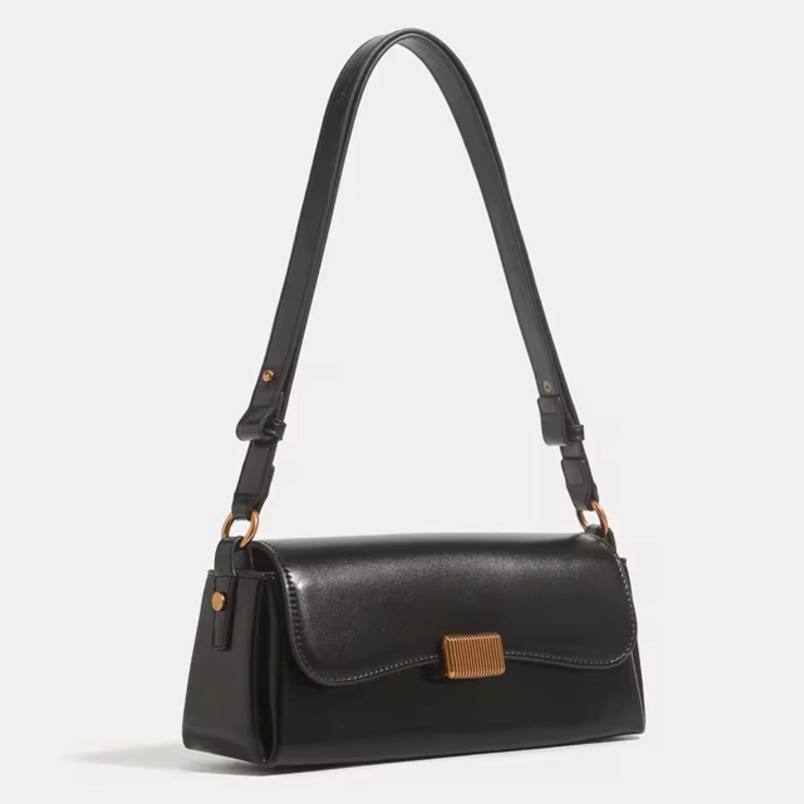 Crimson Muse Shoulder Bag - Black by TIKORI LONDON. Features a structured, elongated "baguette" body with clean, sharp lines and a narrow profile designed to sit snugly under the arm. Picture shows the angle profile of the bag with top handle.