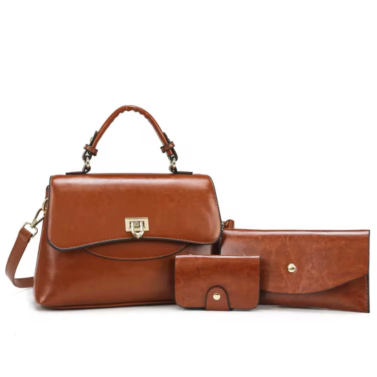 Heritage Flap Bag - Tan  By TIKORI London. Features a beautiful, sweeping front flap secured by a polished, shield shaped gold clasp. Top handle and long strap included. Front of the bag showing with matching wallet and cardholder in a fully white background. Bag displays beautifully showing golden hardware long strap and curved top handle.