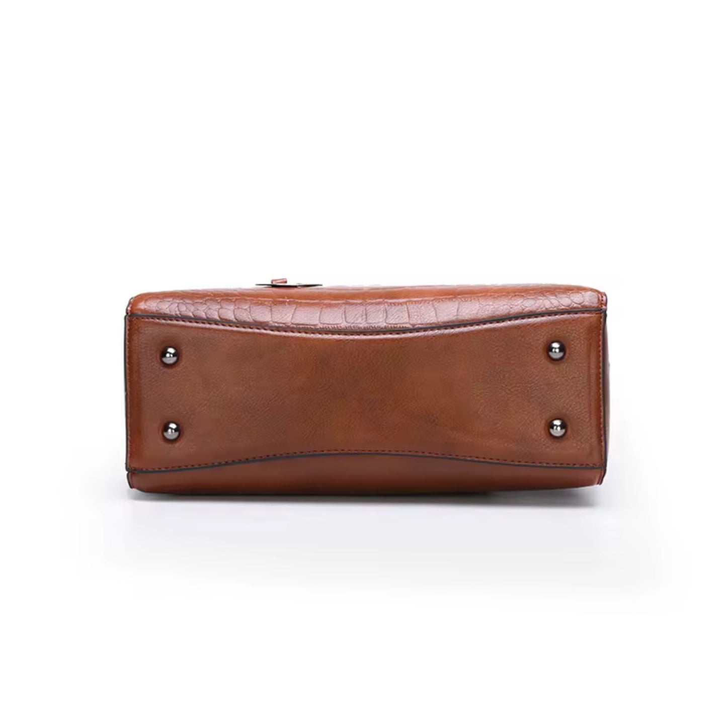 Vintage inspired embossed satchel Black by TIKORI LONDON. Bag featuring a sophisticated crocodile embossed panel across the front for a multi textured look. Silver hardware. Bottom out the bag showing leg detail. 