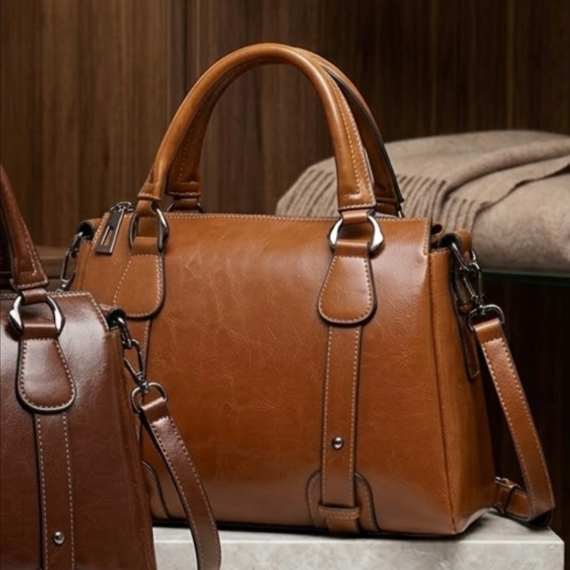 Vintage Brown Polished Satchel Bag - light brown by TIKORI LONDON. Crafted from high quality genuine leather, this bag offers a luxurious aesthetic with a durable finish that stands up to daily wear. Light brown bag displays next to the dark brown but dark brown half of the bag can be seen. In a boutique environment.