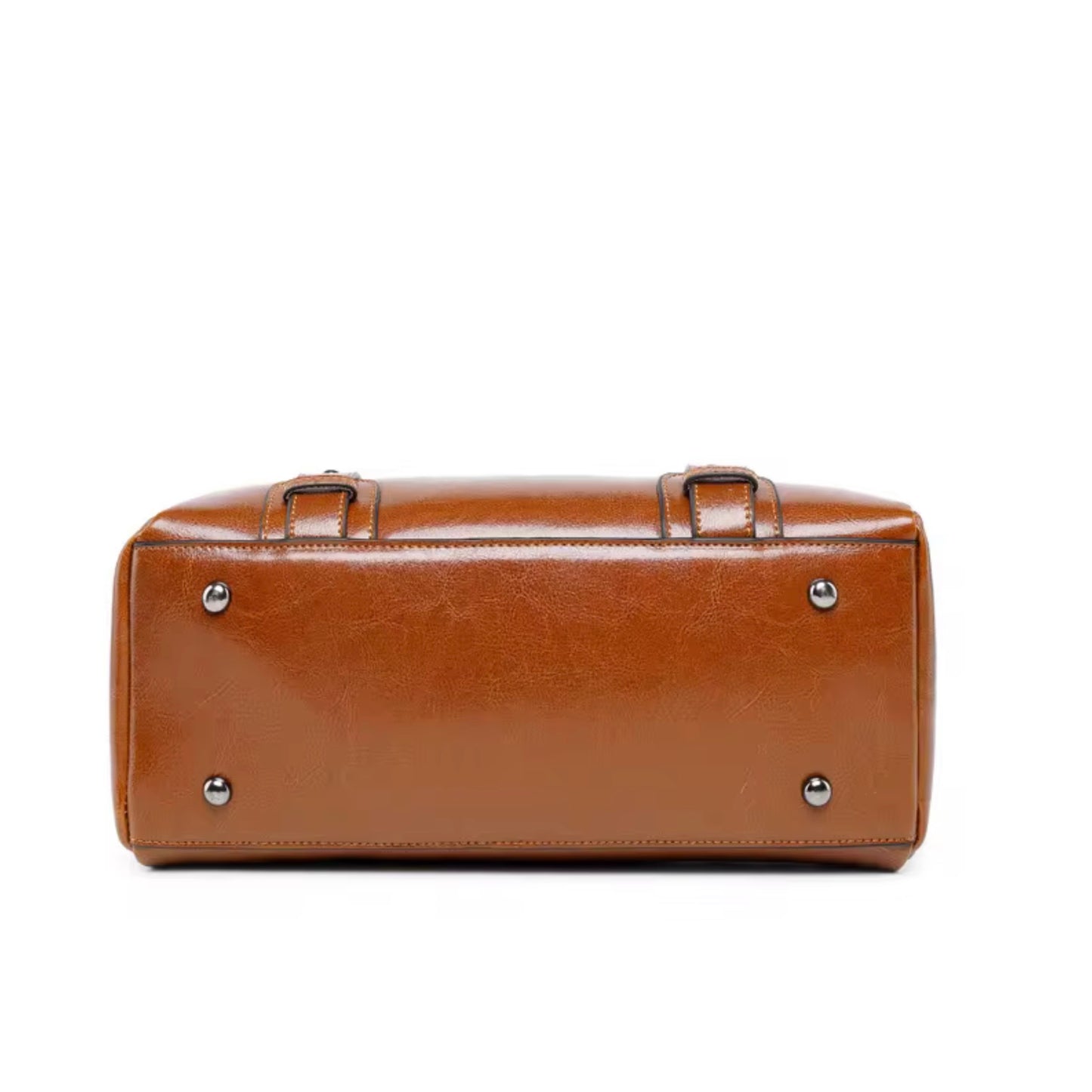Vintage Brown Polished Satchel Bag light brown by TIKORI LONDON. Crafted from high quality genuine leather, this bag offers a luxurious aesthetic with a durable finish that stands up to daily wear. Bottom profile of the bag showing in the picture with light gold legs in a fully white background