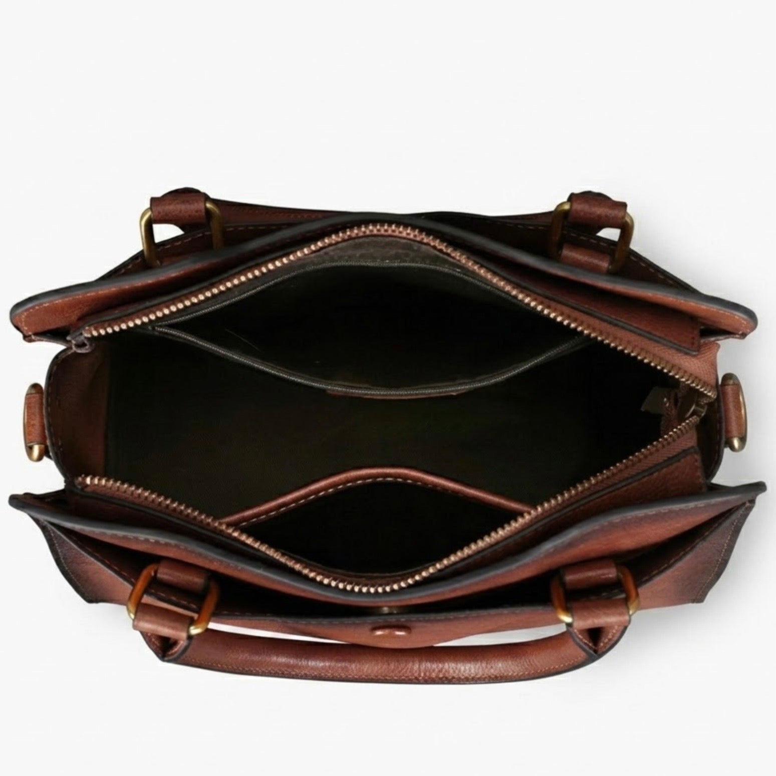 Heritage Burnished Leather Tote by TIKORI LONDON. Each piece features a signature hand burnished finish. This artisanal technique creates a rich, multi tonal gradient, a deep mahogany patina that evolves and grows more beautiful with every year of use. Fin side of the bag showing  in white background. 