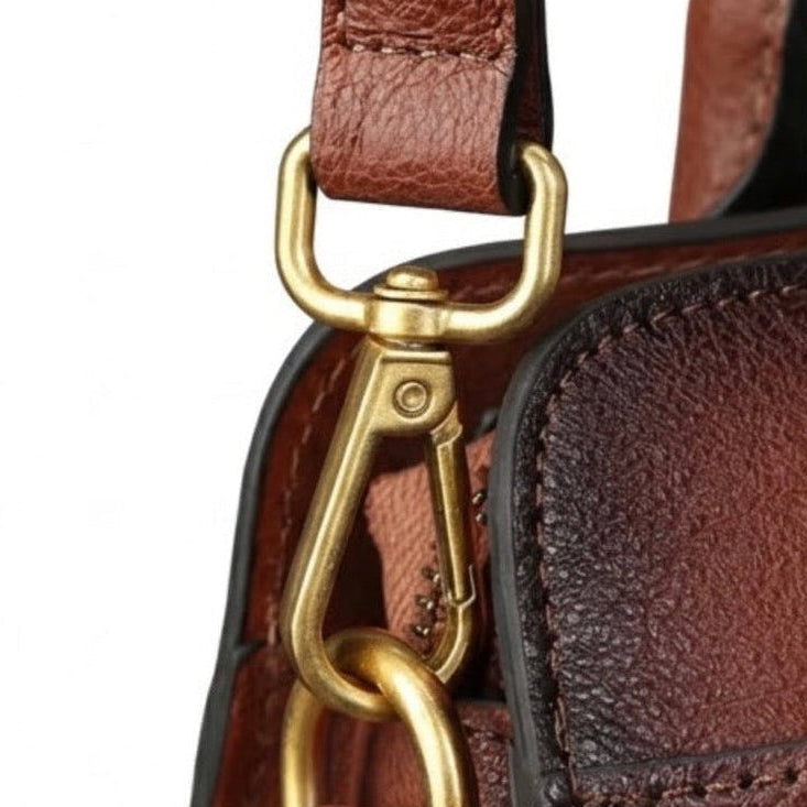 Heritage Burnished Leather Tote - Deep Mahogany By TIKORI london. Close up features of the Bag side buckle shown on the picture with golden tone hardware.