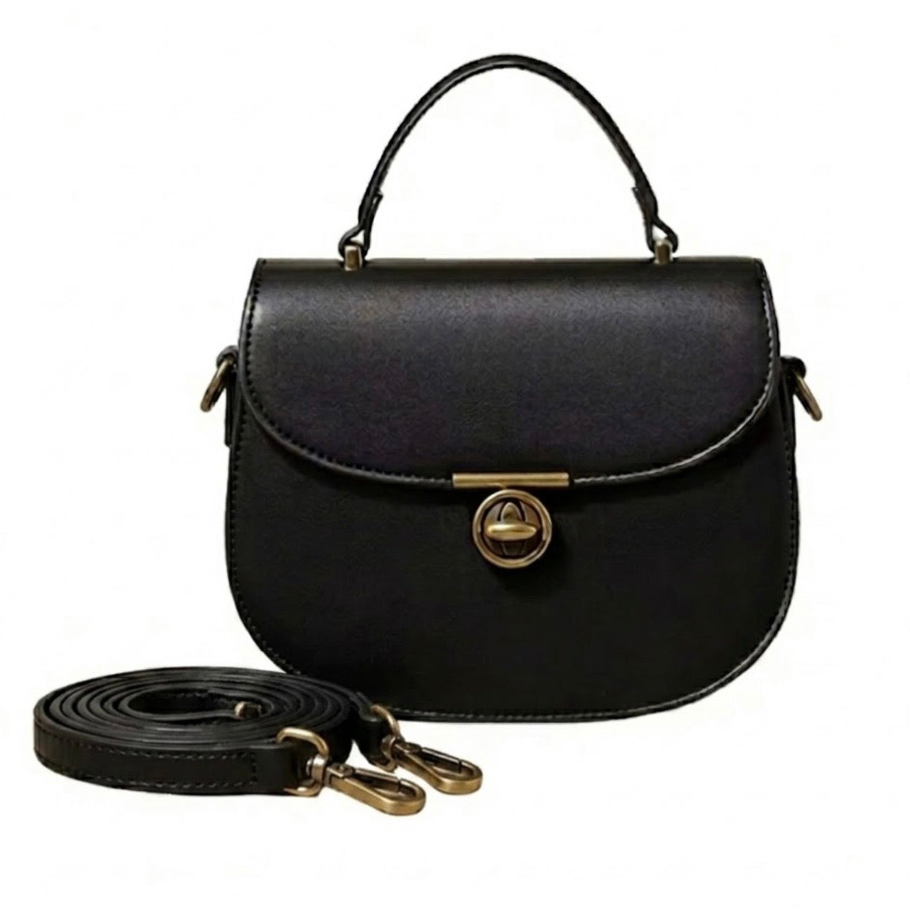 Luna Saddle Bag - Black by TIKORI London. The centrepiece is gold T-bar turn lock, providing a secure closure and a sophisticated focal point. Front profile of the bag showing in the picture with golden hardware and long trap next to the bag. 