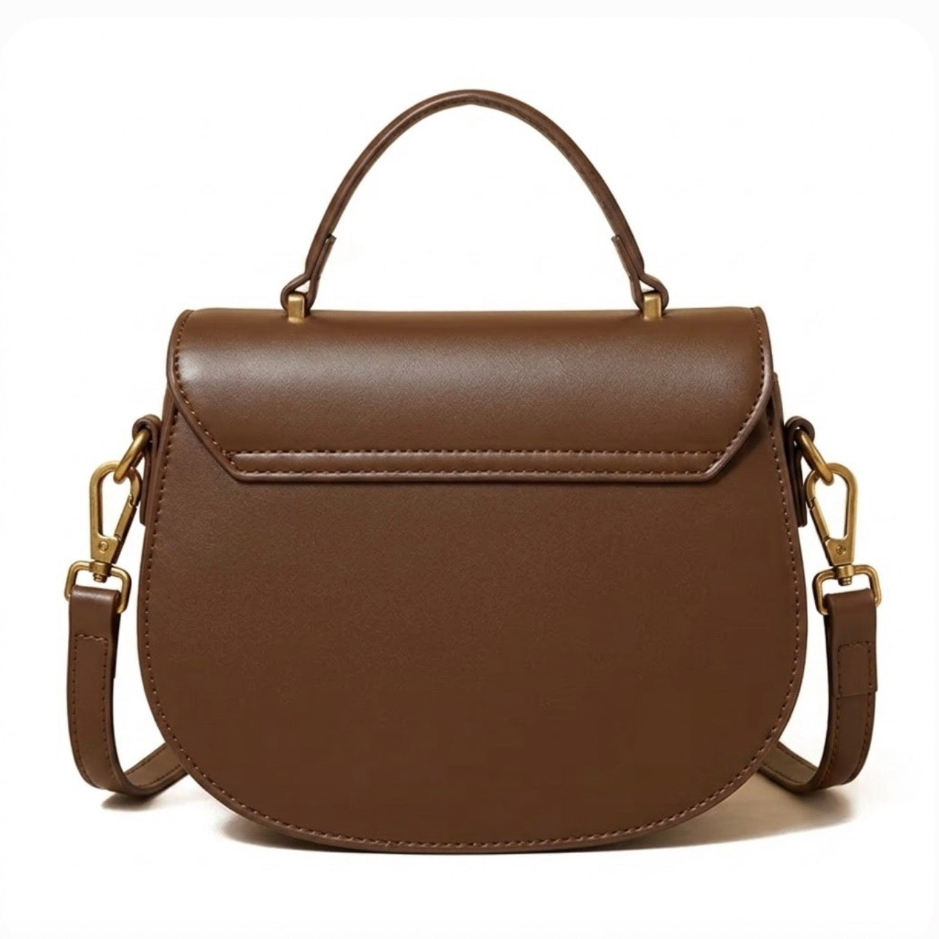 Luna Saddle Bag - Brown  by TIKORI LONDON. The centrepiece is a custom engineered gold T-bar turn lock, providing a secure closure and a sophisticated focal point. Bag featuring Golden tone hardware and long strap. Back  profile of the bag in the picture in a white background.