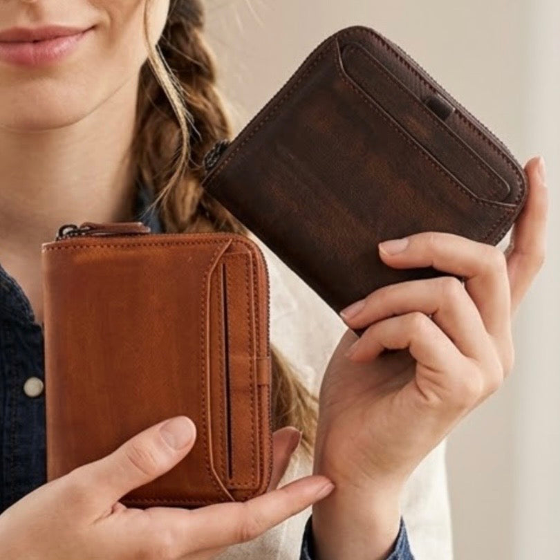 Short box wallets by TIKORI LONDON. beautiful models hands showing the  dark brown and light brown wallets in a cream background. 