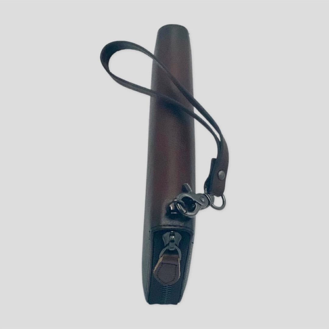 Dark brown TIKORI LONDON wrist strap wallet with compact design and secure strap, suitable for carrying cash and cards. Side of the wallet.