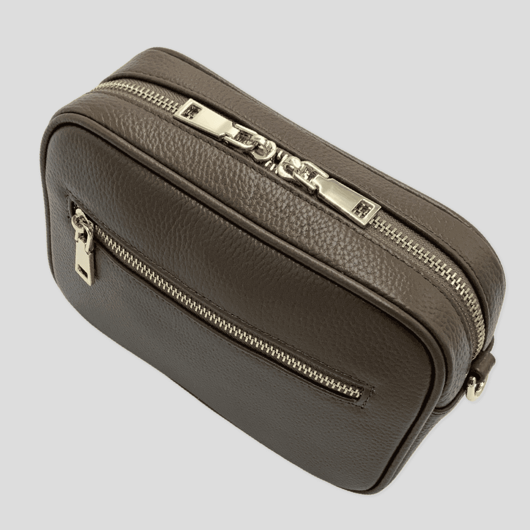 Taupe pebbled leather crossbody bag by Tikori London with adjustable strap and sleek design, perfect for everyday use.