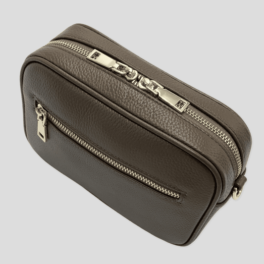 Taupe pebbled leather crossbody bag by Tikori London with adjustable strap and sleek design, perfect for everyday use.