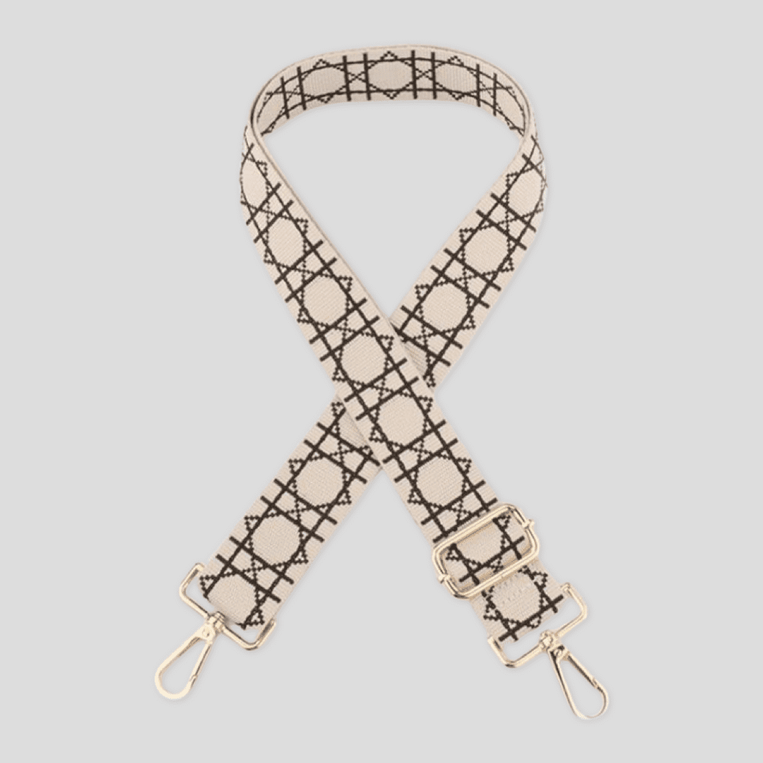 Ivory checkerboard lines crossbody strap by Tikori London with adjustable length and golden metal hardware details. Strap laid showing the golden hardware in a white background.