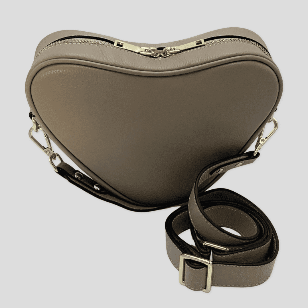 Beige heart-shaped leather crossbody bag by Tikori London, featuring a stylish and compact design perfect for everyday use.