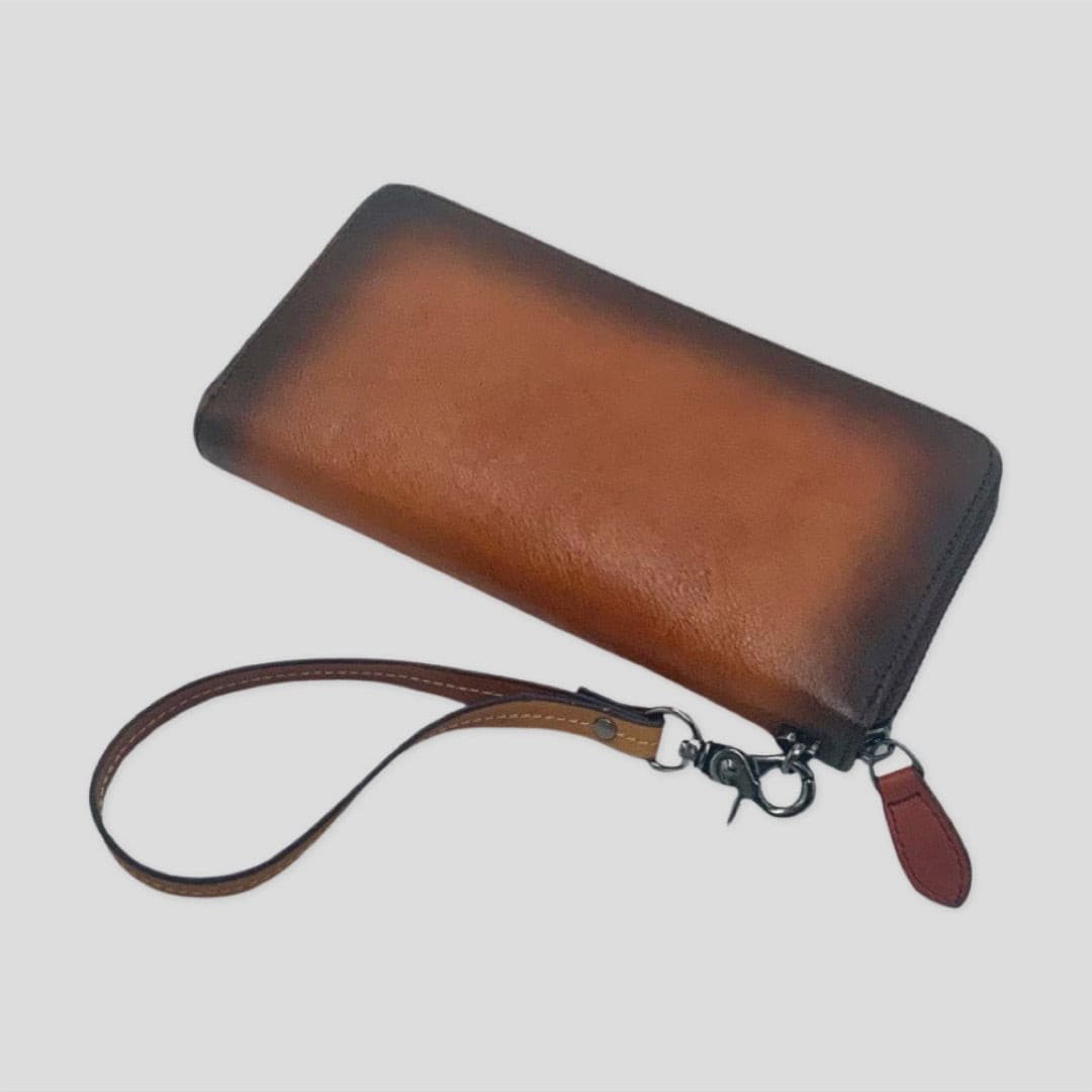 Orange and brown wrist strap wallet by Tikori London, featuring a compact design with a secure strap and multiple card slots. Back.