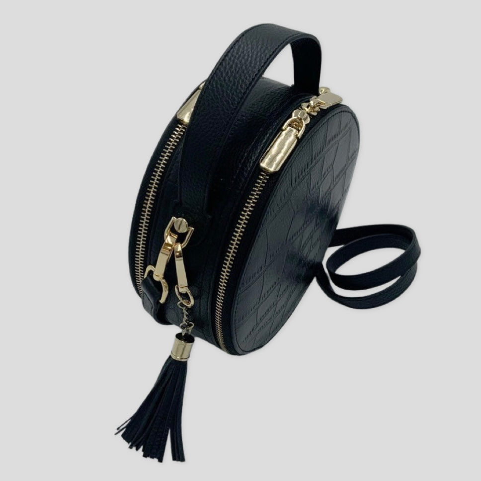 Cleopatra by Tikori London. Black leather circle crossbody bag with dual zip fastening, finished leather and stylish design.